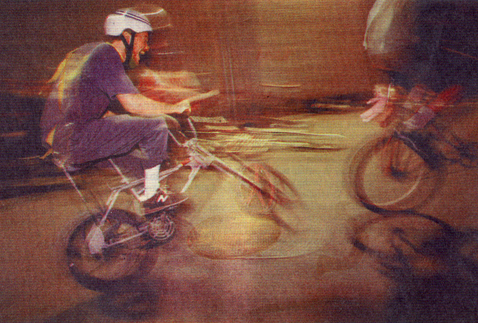 two riders on modified bikes horse around in a parking lot